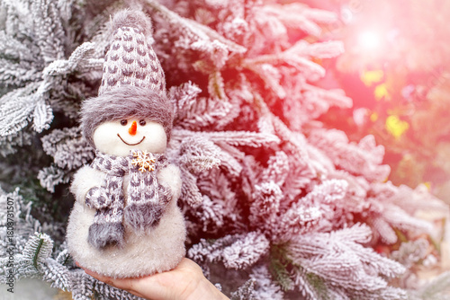 snowman on the background of a Christmas tree
