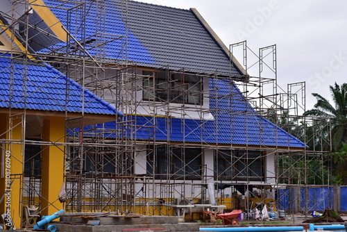 Scaffolding for building improvements, Renovation scaffolding enveloping historical building facade