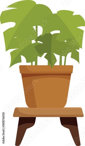 Potted houseplant standing on a small wooden table, creating a cozy and natural atmosphere