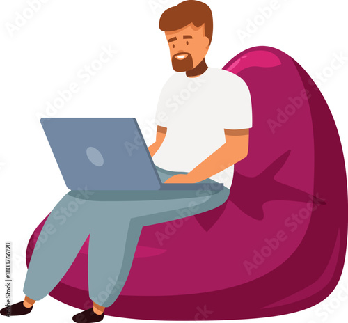 Young man working from home, using laptop while sitting comfortably on beanbag chair