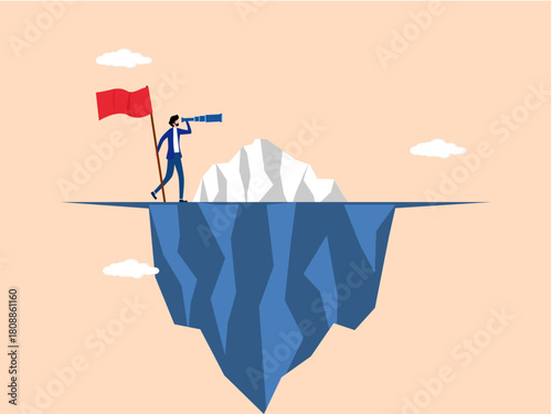 businessman looks through binoculars on an iceberg