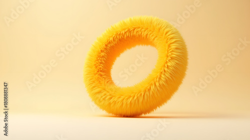 A fluffy yellow circular object with a fuzzy texture, vibrantly contrasting against a soft yellow background.