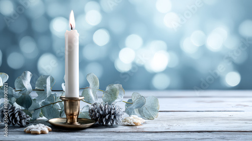 A beautiful candle surrounded by eucalyptus and pinecones on a rustic wooden table, evoking a peaceful holiday ambiance