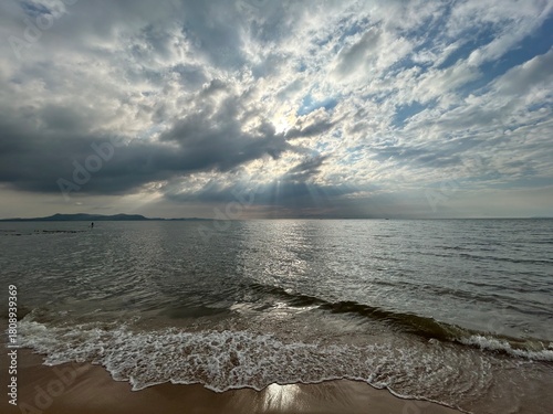 Sun under the clouds at the sea
