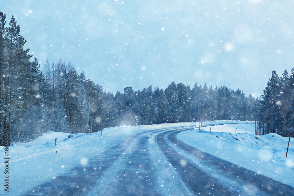 Naklejka premium snowfall on a winter road, abstract background, blurred highway backdrop snowy landscape