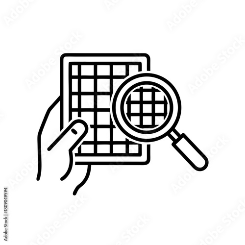 Hand holding an air filter with magnifying glass inspecting details  