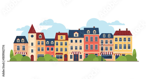 Charming street scene of colorful old European-style townhouses and shops with a cloudy blue sky in the background.