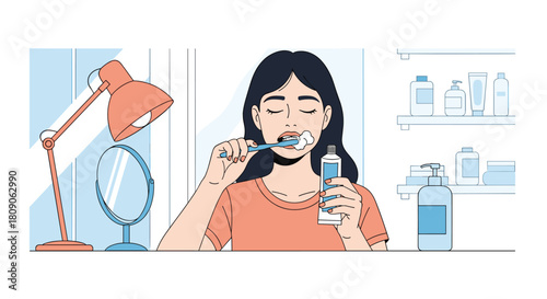 Young woman brushing her teeth with toothpaste as part of her morning or evening routine in a modern-style bathroom.