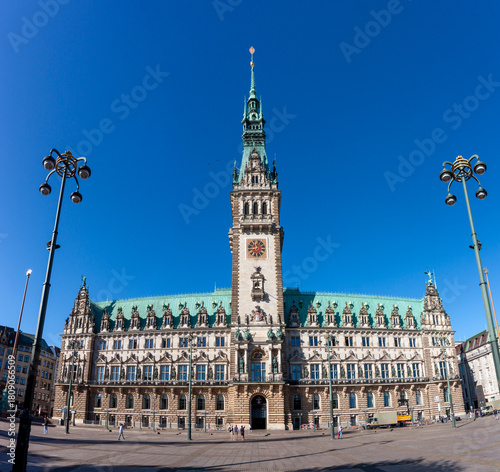 Hamburg City Hall in Germany, a grand Neo-Renaissance building with its prominent tower and intricate facade under a clear blue sky