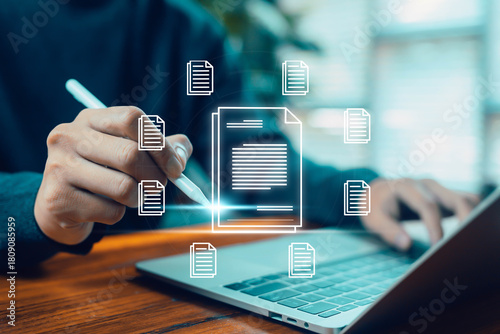 A person using a digital pen to manage and organize electronic documents on a laptop, representing digital file management, cloud documents, workflow organization, and modern online document systems.