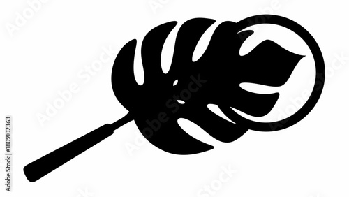 A black and white silhouette of a monstera leaf within a circular magnifying glass design element