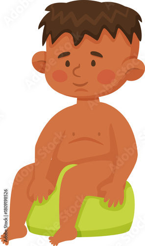 Young boy doing potty training on a green seat