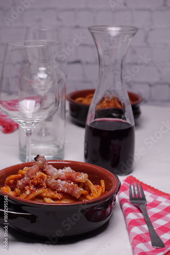 Wallpaper Mural Tavola apparecchiata per due con piatti di coccio con bucatini all'amatriciana, piatto tipico italiano Torontodigital.ca