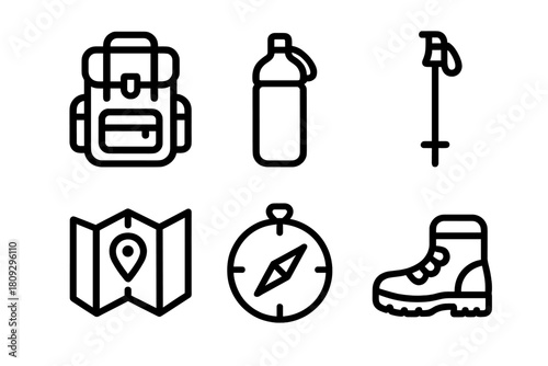 Essential outdoor gear set with backpack, map, compass, and hiking boot