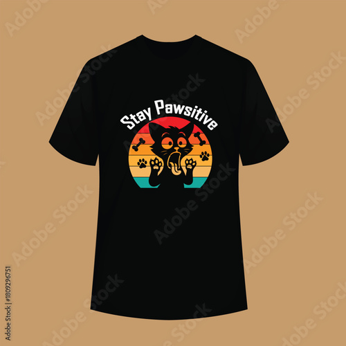 A fun retro  vintage T-shirt design featuring a cute cartoon cat with raised paws and the positive quote “Stay Pawsitive.”
