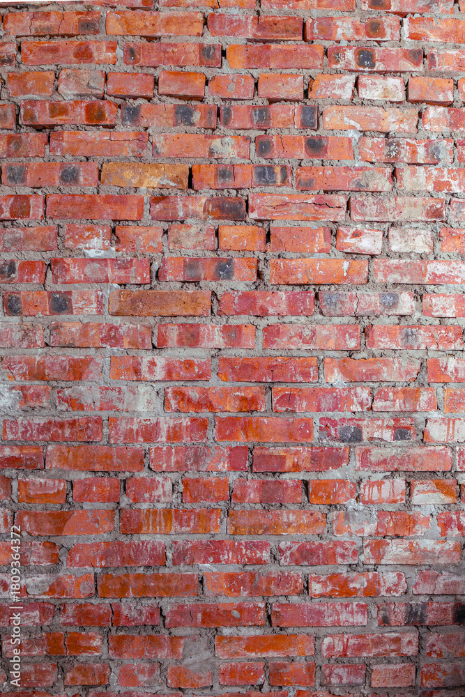 Fototapeta premium Old red brick wall texture with rough surface and natural worn details, perfect for backgrounds and design projects