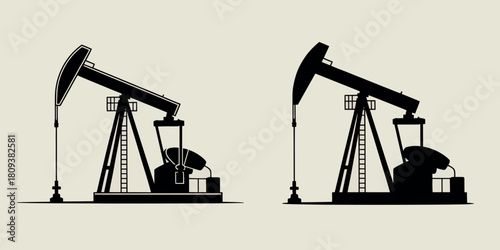 Silhouette of two oil pump jacks against a light background