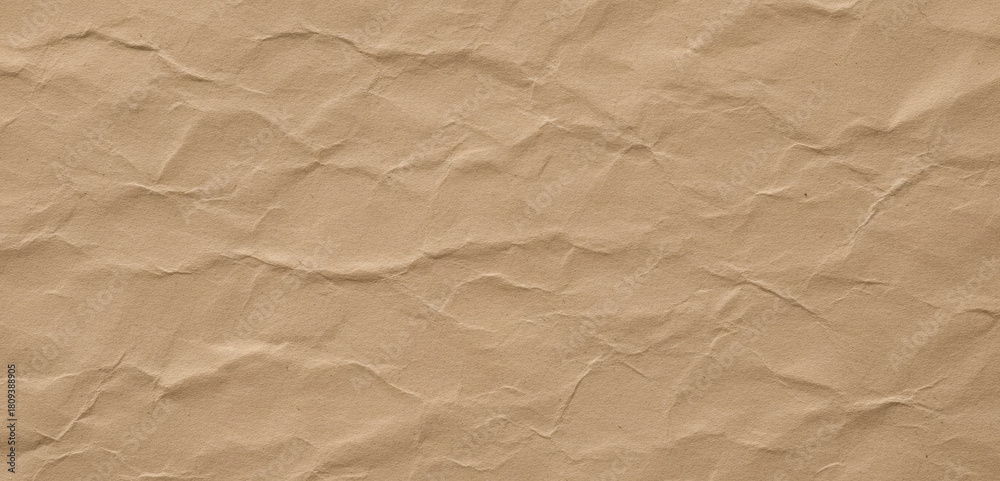 Obraz premium Brown wrinkled paper texture background close up detail, showing natural folds and creases with rich earthy tones that emphasize its raw organic visual character.