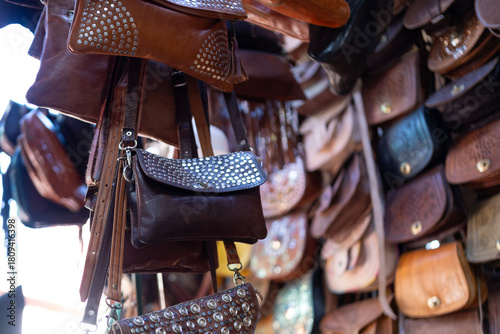 Colorful Vibrant leather handmade Moroccan bags, goods for sale in traditional local souk, story heritage and authentic oriental craftsmanship, artisanal culture Morocco