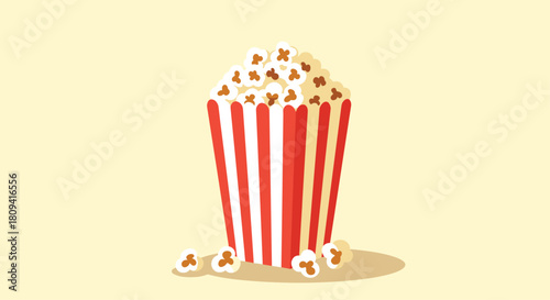Classic red and white striped carton is full of delicious buttery popcorn for a movie night.
