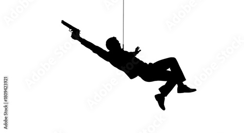 Dramatic silhouette of a man falling backwards with a gun, action concept for crime thriller or suspense movie, cinematic and intense scene