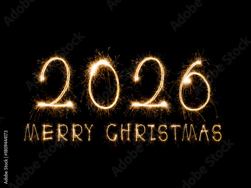 Happy New Year 2026. Burning sparkling text 2026 isolated on black background.