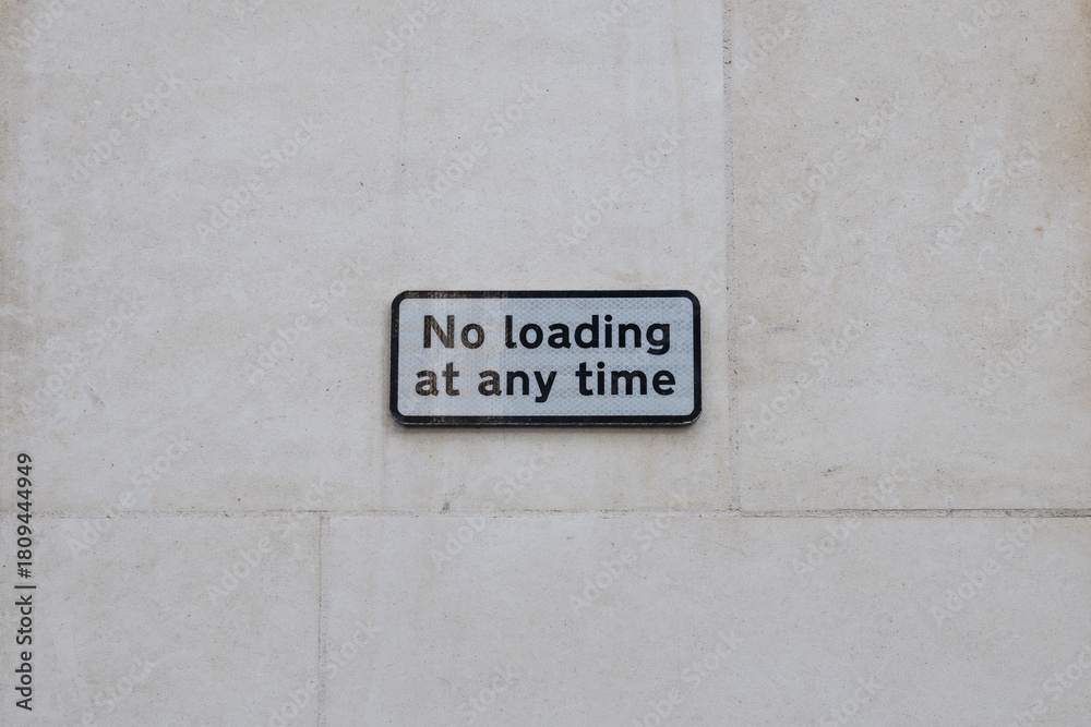 Fototapeta premium No Loading at Any Time Sign on Light Stone Wall