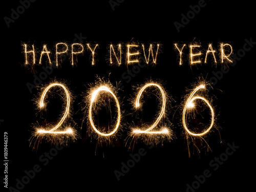 Happy New Year 2026. Burning sparkling text 2026 isolated on black background.