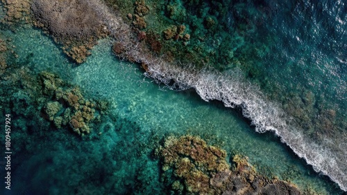 Fototapeta Naklejka Na Ścianę i Meble -  Aerial view of turquoise sea around a coral reef with white waves breaking on a rocky shoreline. Concept Turquoise sea, Coral reef, Aerial view, White waves breaking, Rocky shoreline