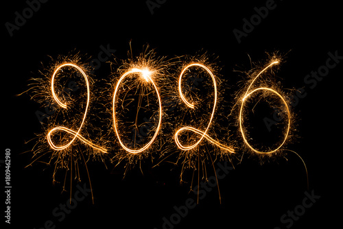 Happy New Year 2026. Burning sparkling text 2026 isolated on black background.
