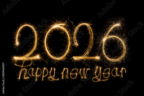 Happy New Year 2026. Burning sparkling text 2026 isolated on black background.