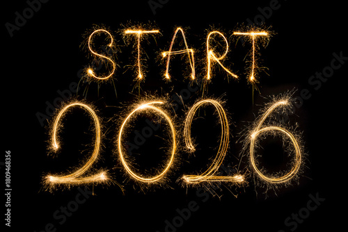 Happy New Year 2026. Burning sparkling text 2026 isolated on black background.