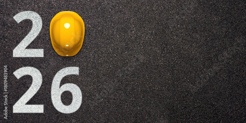 Creative 2026 New Year design template with yellow protective helmet and grey asphalt background. 3D render illustration on an engineering, logistics or road construction theme.
