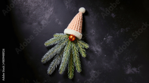Cute christmas gnome made from pine branches and a knitted hat