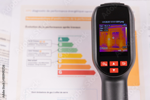 Une caméra thermique avec le dossier de diagnostic DPE d'un appartement pour détecter les fuites de chaleur.