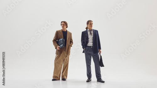 Tableau sur toile Two stylish male professionals posing confidently in modern tailored office outfits