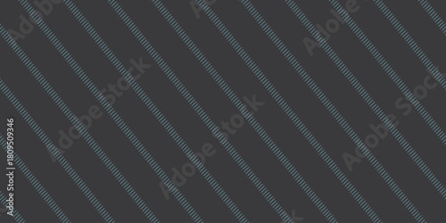 A dark gray background with thin diagonal lines of alternating short and long dashes in a repeating pattern