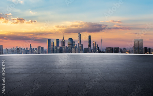 Empty square floor and city skyline with modern commercial buildings at beautiful sunrise in Guangzhou
