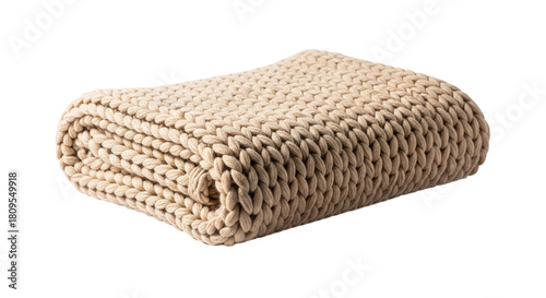 Folded beige knitted blanket, a cozy and warm textile for snuggling up on the couch or bed on a cold winter day