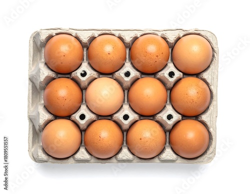Top-down shot of twelve brown eggs neatly arranged in a recycled, gray-brown cardboard carton, isolated on white