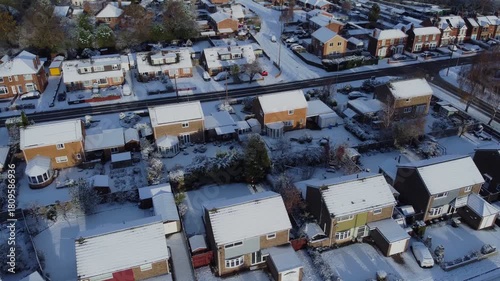 Drone 50fps. UK houses, rooftops covered in snow.  Cold Winter, Christmas season.
