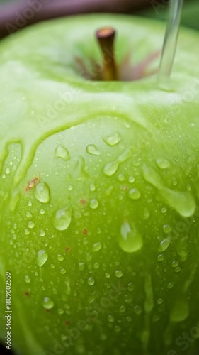 Crisp vibrant green apple being washed with fresh water a healthy lifestyle choice full of vitamins and freshness for a healthy snack