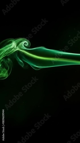 Ethereal green smoke gracefully dancing against a dark backdrop, creating a mesmerizing and dreamy atmosphere perfect for abstract art