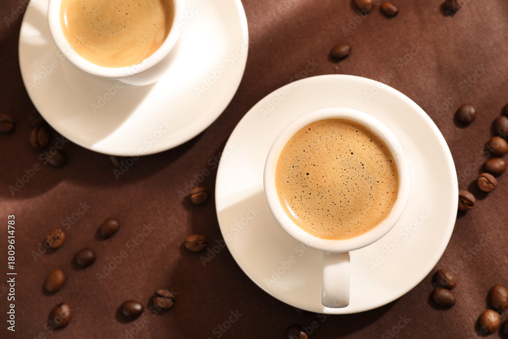 Obraz premium Aromatic coffee in cups and beans on table, flat lay