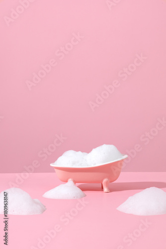 Pink miniature bathtub in pink bathroom with bubble