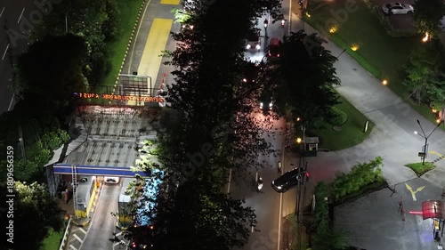 Wallpaper Mural A stunning aerial night view of the city captured by drone, showcasing illuminated buildings and moving cars creating dynamic light trails along the busy roads.  Torontodigital.ca