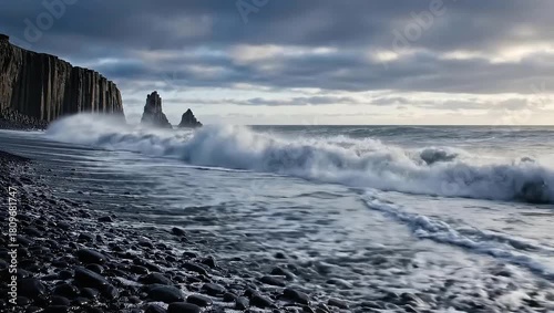Powerful ocean waves crashing on a black sand beach
