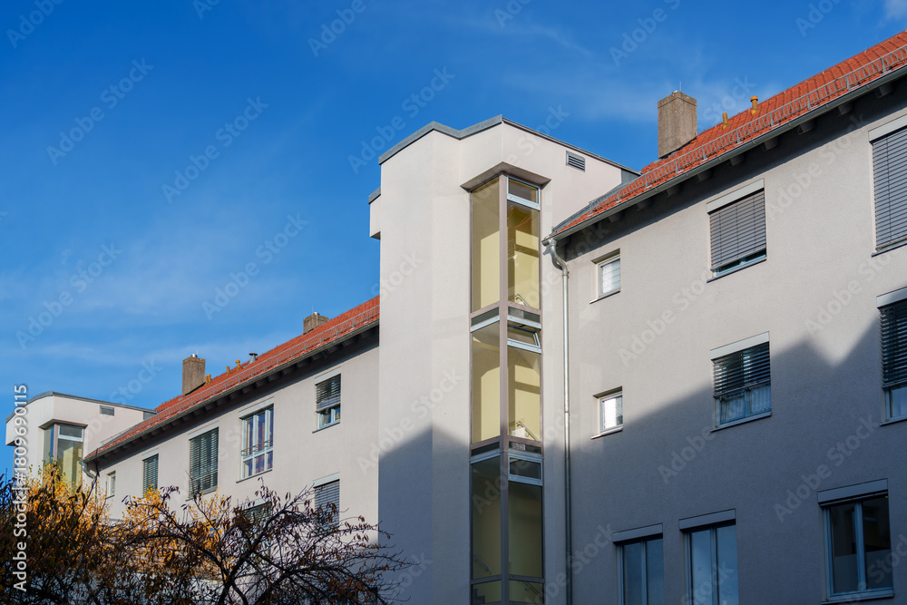 Fototapeta premium Modern apartment building with unique architecture in a clear blue sky during daytime