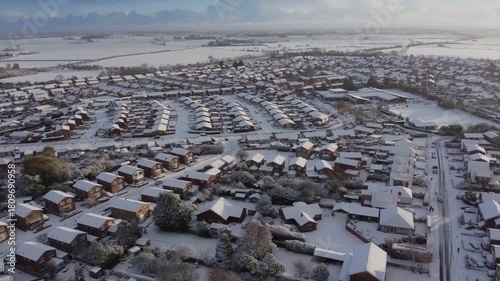 Drone. UK houses covered in snow. Icy winter, Christmas season.