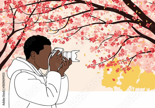 A young Black photographer captures cherry blossoms with a camera. Vibrant pink blooms frame the shot, creating a beautiful, spring scene. ?Snap the Scarlet?